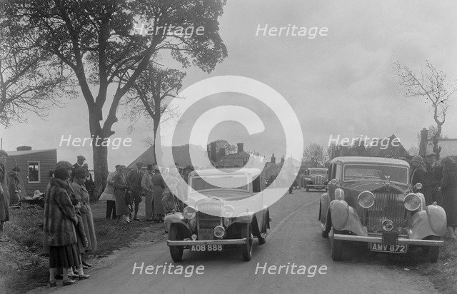 Austin sports saloon of Mrs MS Flewitt and Rolls-Royce saloon at the RSAC Scottish Rally, 1934. Artist: Bill Brunell.