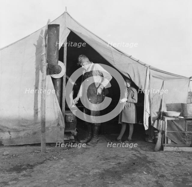 Supper time in FSA migratory emergency camp...in the pea fields, Calipatria, California, 1939. Creator: Dorothea Lange.