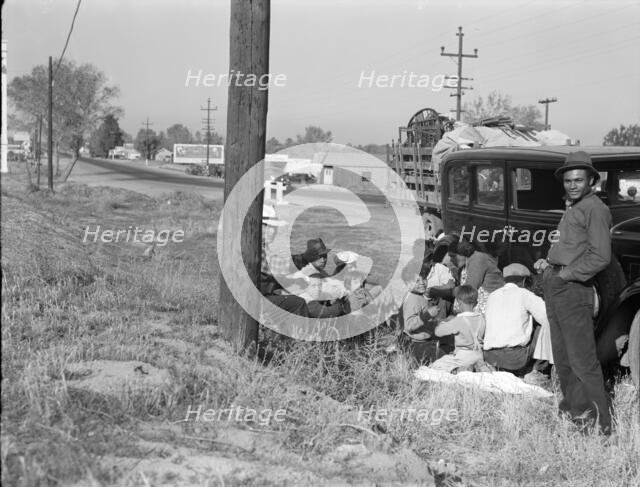 Mexicans bound for the Imperial Valley to harvest peas, near Bakersfield, California, 1936. Creator: Dorothea Lange.
