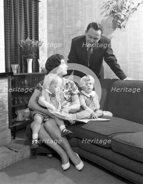 Family group looking at a brochure, Doncaster, South Yorkshire, 1963. Artist: Michael Walters