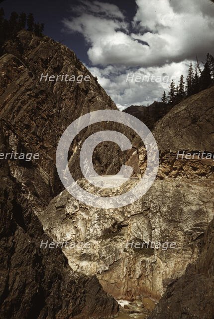 Million dollar highway [U.S. 550] is cut through massive rocks in Ouray County, Colorado, 1940. Creator: Russell Lee.