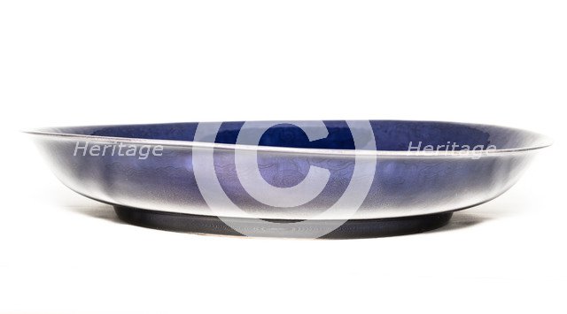 Deep aubergine dish with carved dragons chasing flaming pearl, 1662-1722. Artist: Unknown.