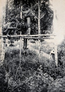 Sarawak: two Kenyah people boring a blowpipe, c1900. Creator: Unknown.