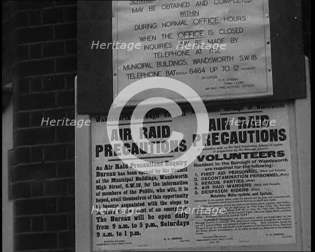 Notices Containing Information About 'Air Raid Precautions' and Asking For Volunteers..., 1938. Creator: British Pathe Ltd.