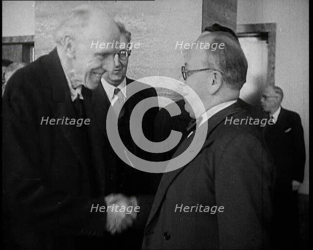 Two Male League of Nations Delegates Greeting Each Other By Shaking Hands While Two Other..., 1937. Creator: British Pathe Ltd.