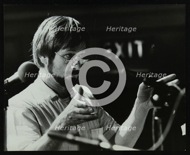 Michael Garrick conducting an orchestra at Berkhamsted Civic Centre, 1985. Artist: Denis Williams