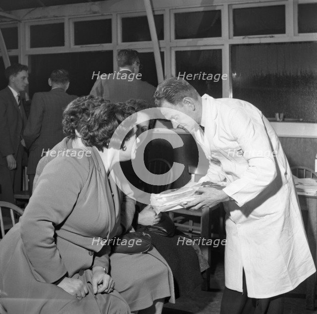 Butcher from Danish Bacon giving a demonstration, Kilnhurst, South Yorkshire, 1961.  Artist: Michael Walters