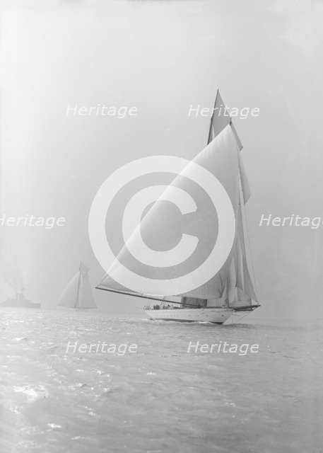 The 250 ton schooner 'Germania' running under spinnaker, 1913. Creator: Kirk & Sons of Cowes.