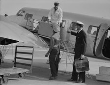 Unloading baggage for inspection...plane from Mexico, Glendale Airport, California, 1937. Creator: Dorothea Lange.