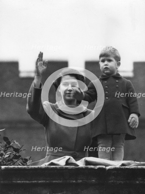Princess Elizabeth and a two year old Prince Charles wave from Buckingham Palace, 1950.   Creator: Unknown.