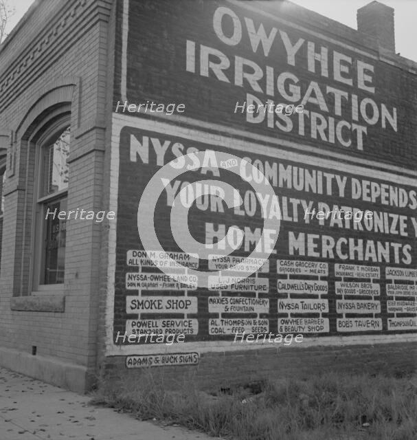 Sign on old bank building which now houses office of Bureau..., Nyssa, Malheur County, Oregon, 1939. Creator: Dorothea Lange.