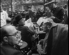 French Police Checking People's Papers Outside a Cafe in Paris, 1940. Creator: British Pathe Ltd.