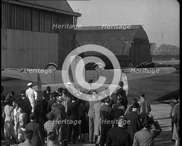 A Small Crowd at Heston Aerodrome Cheering the Moving Lockheed Aeroplane Carrying the..., 1938. Creator: British Pathe Ltd.