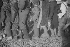 Possibly: Negroes at mealtime in the flood refugee camp, Forrest City, Arkansas, 1937. Creator: Walker Evans.