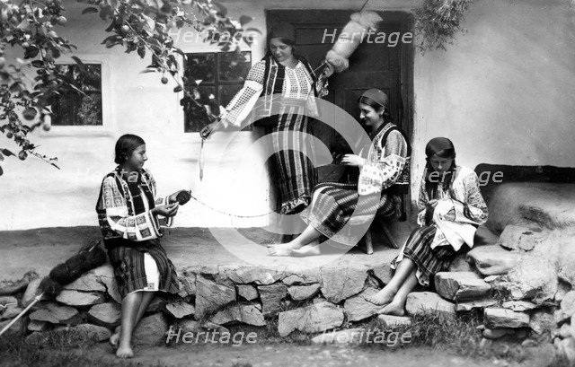 Young women spinning and sewing, Bistrita Valley, Moldavia, north-east Romania, c1920-c1945. Artist: Adolph Chevalier