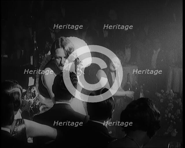 Female Civilian Singing in a Nightclub. She Walks Towards a Male Civilian and Dances in..., 1924. Creator: British Pathe Ltd.