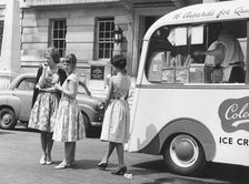 Young women by an ice cream van, c1960.
