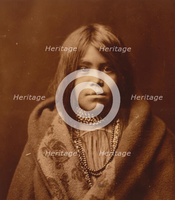 An Apache girl, head-and-shoulders portrait, facing front, wearing bead necklace..., c1903. Creator: Edward Sheriff Curtis.