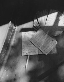 Song sheets and a fan left behind in an abandoned church on Independence Ave, Washington, D.C, 1942. Creator: Gordon Parks.