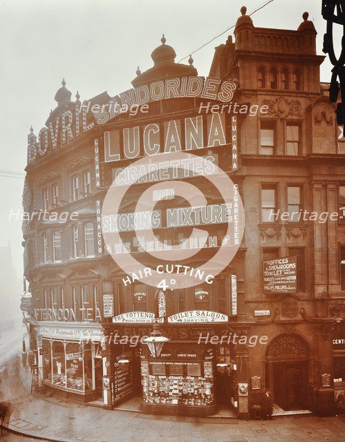 Illuminated advertisements on shop fronts at 7, Oxford Street, London, 1909. Artist: Unknown.