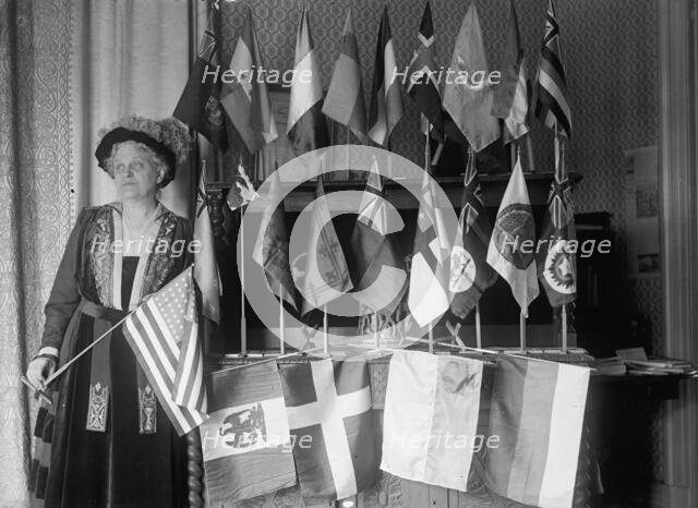 Mrs. Carrie Chapman Catt with Flags of 22 Nations, 1917. Creator: Harris & Ewing.