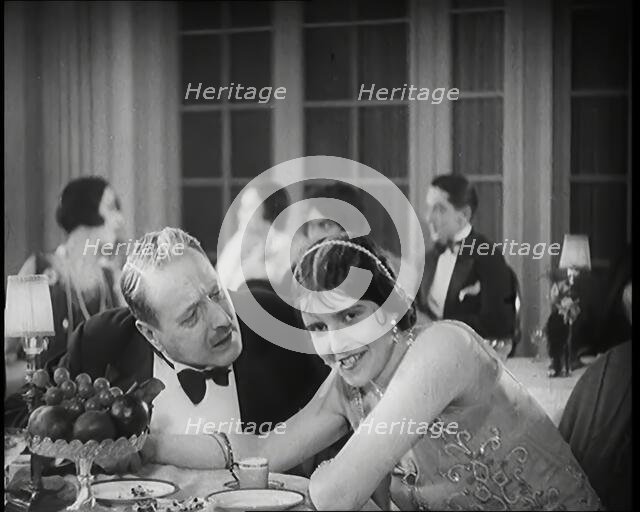 Scene from the Film 'Champagne': Two Actors Sitting at a Table in a Nightclub, 1920s. Creator: British Pathe Ltd.