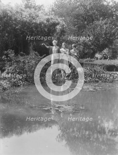 People wearing masks made by W.T. Benda, 1925 Sept. 20. Creator: Arnold Genthe.