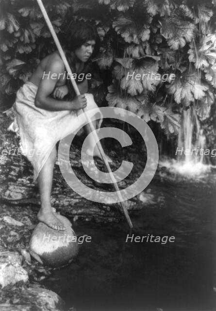 Spearing salmon, c1923. Creator: Edward Sheriff Curtis.
