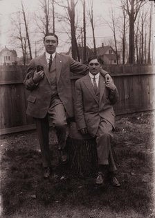 Untitled (two men holding small dog; one sitting on a stump, Fisher St., backyard), c1915. Creator: Wendell Hotter.