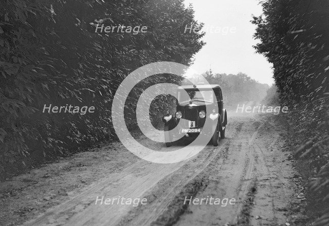 Riley Monaco saloon competing in the Brighton & Hove Motor Club Trial, 1920s. Artist: Bill Brunell.