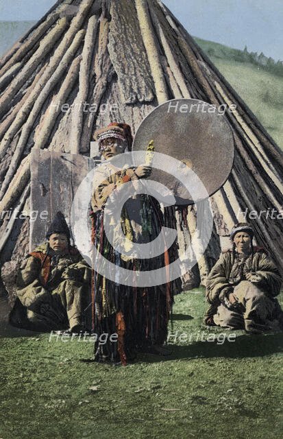 Altai Shaman with Tambourine in Front of a Traditional Dwelling (Chaadyr), 1911-1913. Creator: Sergei Ivanovich Borisov.