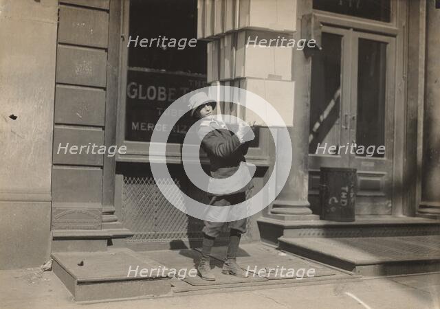 Wagon boy or "tail boy" helping to load the wagon, c. 1914. Creator: Lewis Wickes Hine.