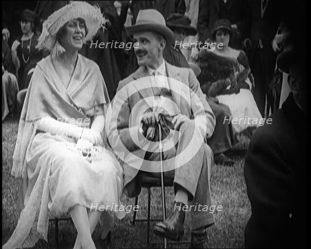 Female Civilian and Male Civilian Sitting on Chairs, 1924. Creator: British Pathe Ltd.