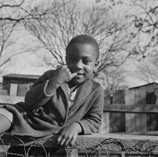 Boy playing on a fence, Washington (southwest section), D.C., 1942. Creator: Gordon Parks.