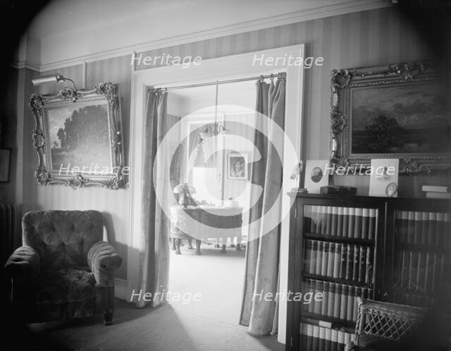 Room with bookcase, study with desk, between 1900 and 1915. Creator: Unknown.