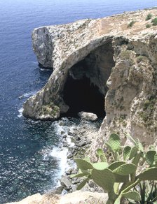 View of natural bridge and boat, Blue Grotto, Malta