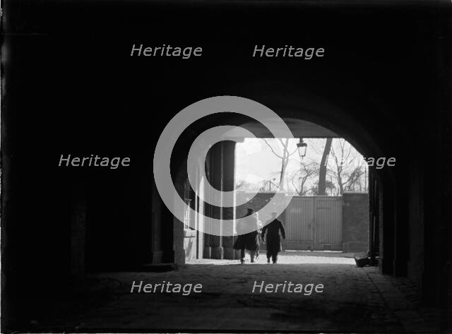 Tunnel or covered passage looking towards three figures, Greater London Authority, 1930s. Creator: Charles William  Prickett.