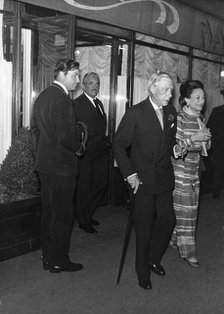 The Duke and Duchess of Windsor coming out of Maxim's restaurant, Paris. Artist: Unknown