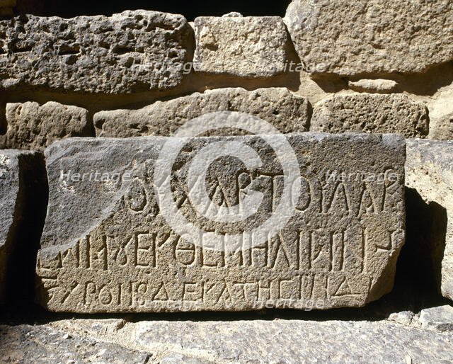 Inscription carved on a stone slab, Roman Theatre, Bosra (Busra al-Sham), Syria, 2001. Creator: LTL.