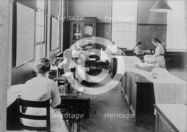 Girl Scouts - War Sewing with Red Cross, 1917. Creator: Harris & Ewing.