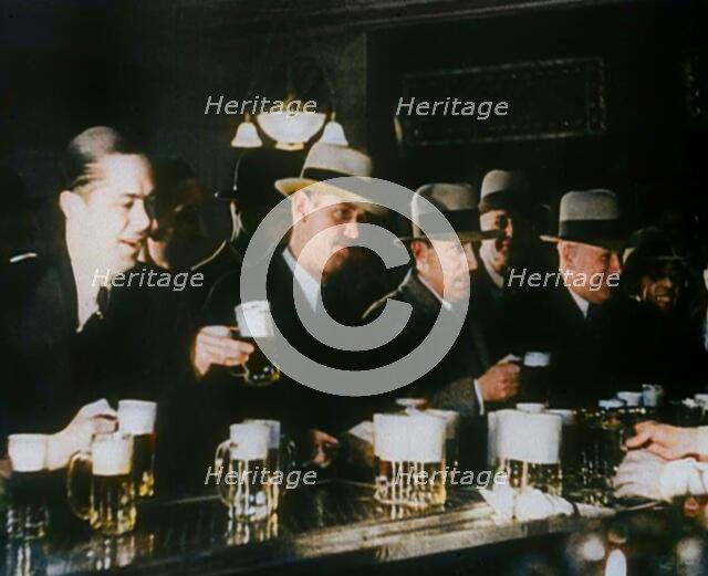 American Civilians Celebrating the End of Prohibition Drinking in a Bar, 1930s. Creator: British Pathe Ltd.