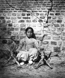 Child sitting by a wall, Korea, c1900. Artist: Unknown