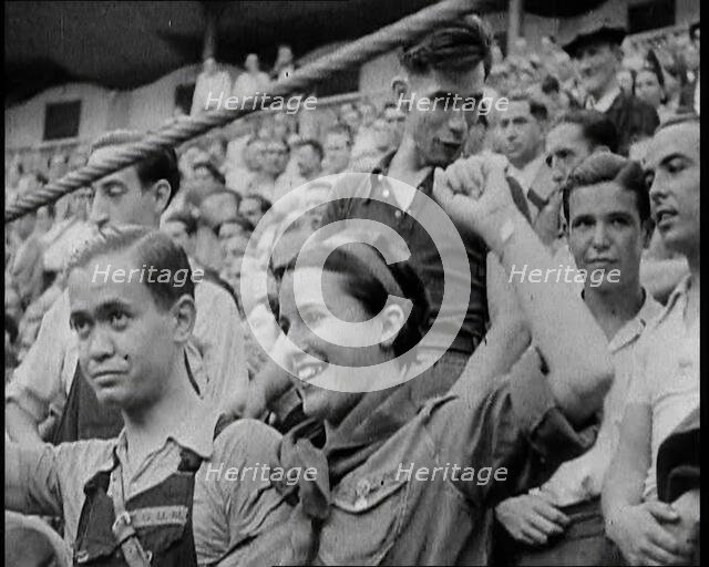 Spectators at Bullring Cheering Parading Government Fighters, Including Woman With Raised..., 1937. Creator: British Pathe Ltd.
