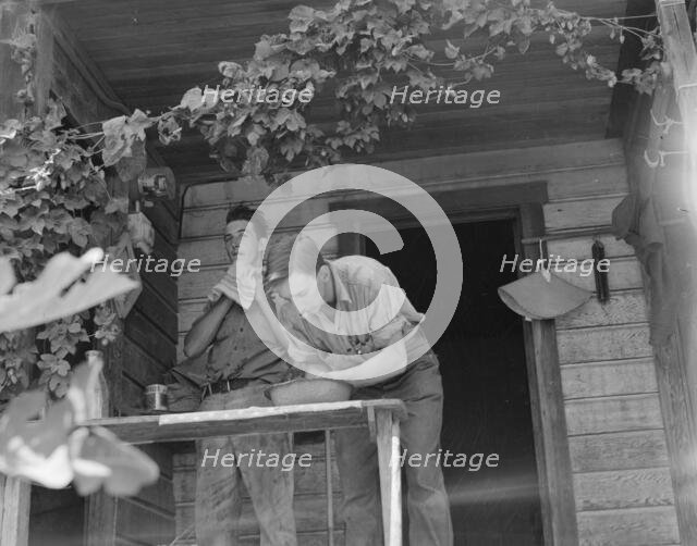 Hop farmer's sons, washing for noon meal on back porch, Independence, Polk County, Oregon, 1939. Creator: Dorothea Lange.