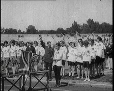 Female British Olympic Athletes Doing the Olympic Salute at the Women's World Games, 1922. Creator: British Pathe Ltd.