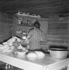 Wife of tobacco sharecropper putting breakfast dishes away. Person County, North Carolina, 1939. Creator: Dorothea Lange.