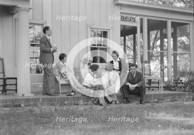 Rothbart, Albert, Mr., group, seated on a porch, between 1920 and 1935. Creator: Arnold Genthe.