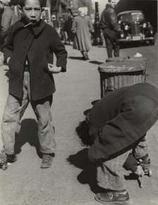 105th Street - Two boys playing with roller skates, each wearing a single roller..., 1947 - 1951. Creator: Romulo Lachatanere.