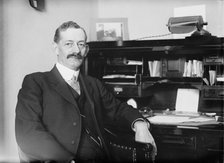 Robt. N. Page seated at desk, 1916. Creator: Bain News Service.