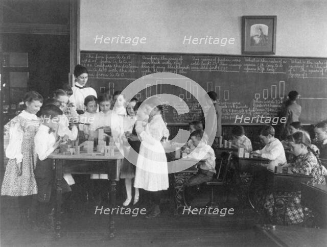 Classroom scene in Washington, D.C. elementary school - children working with blocks..., (1899?). Creator: Frances Benjamin Johnston.